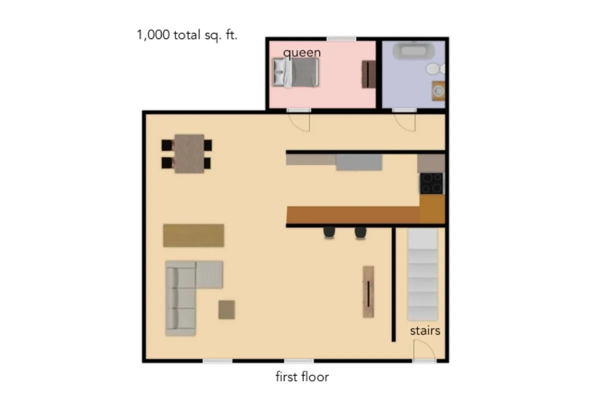 This cozy interior showcases a family-friendly open living space with a dining area, kitchen counter with bar stools, living area for relaxing, and stairs leading to additional rooms. The arrangement invites gatherings and shared moments.