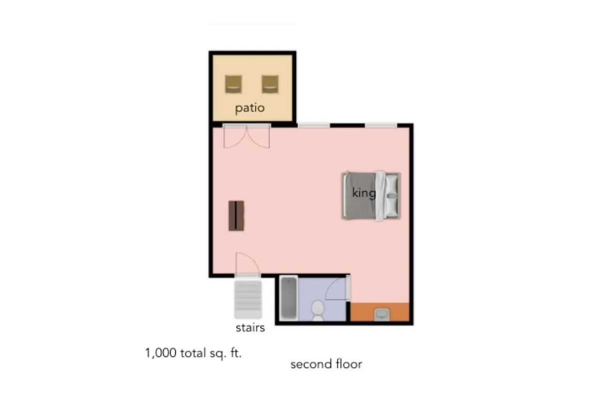 A spacious bedroom with a king bed and stylish decor, adjacent to a private patio area. The room is bathed in soft daylight, with the patio visible through glass doors, hinting at both comfort and an indoor-outdoor connection.